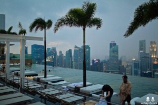 Photos of Marina Bay Sands hotel in Singapore with a roof pool on top of towers